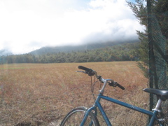 clouds flowing over a hill to the south